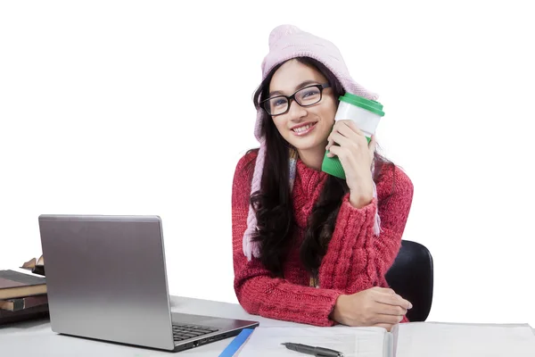 Student in winter clothes studying on table — Stock Photo, Image