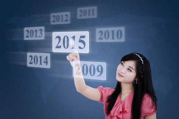 Female manager selects a button 2015 — Stock Photo, Image