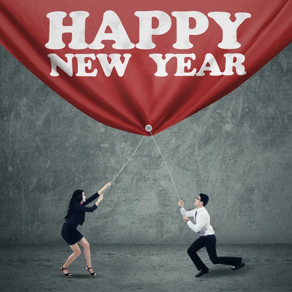 Two business person drag new year banner — Stock Photo, Image