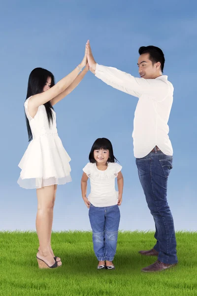 Sweet girl playing with parents outdoors — Stock Photo, Image