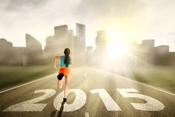 Woman running towards the future — Stock Photo, Image
