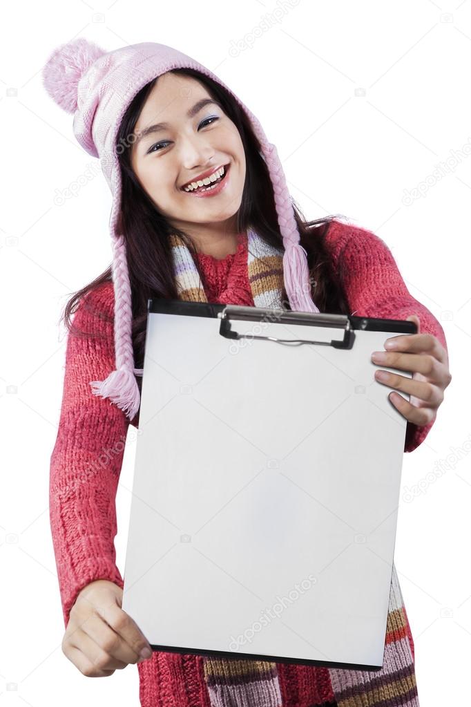 Attractive student showing empty clipboard