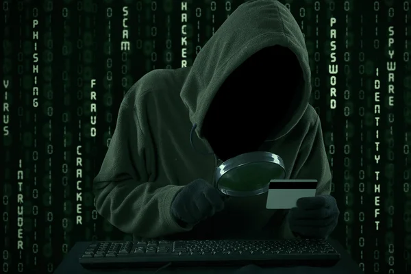 Hacker looking for credit card code — Stock Photo, Image