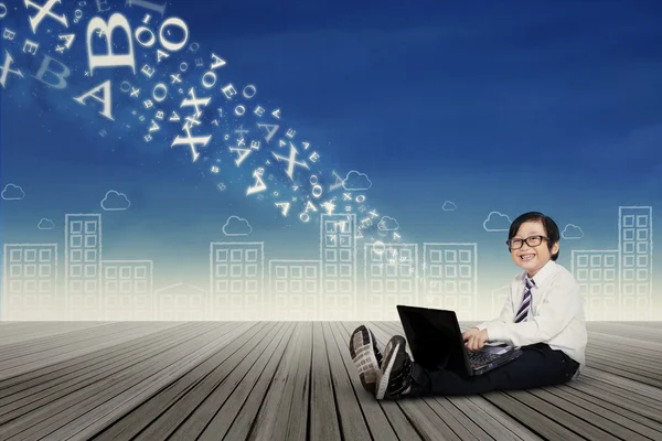 Little boy using laptop to send information — Stock Photo, Image