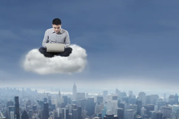 Man using laptop over cloud 1 — Stock Photo, Image