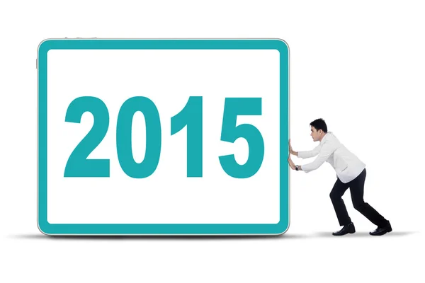 Male doctor pushing number 2015 on a board — Stock Photo, Image