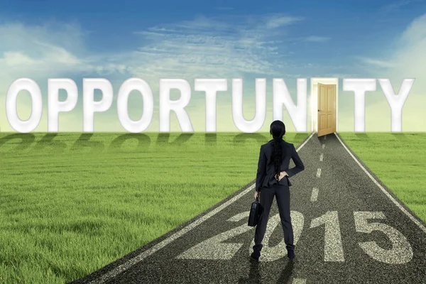 Woman on the opportunity road with an opened door — Stock Photo, Image