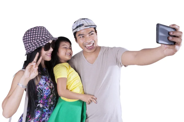 Joyful family taking pictures in studio — Stock Photo, Image