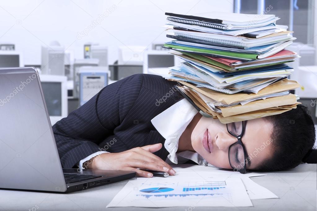 Indian businesswoman sleeping in office