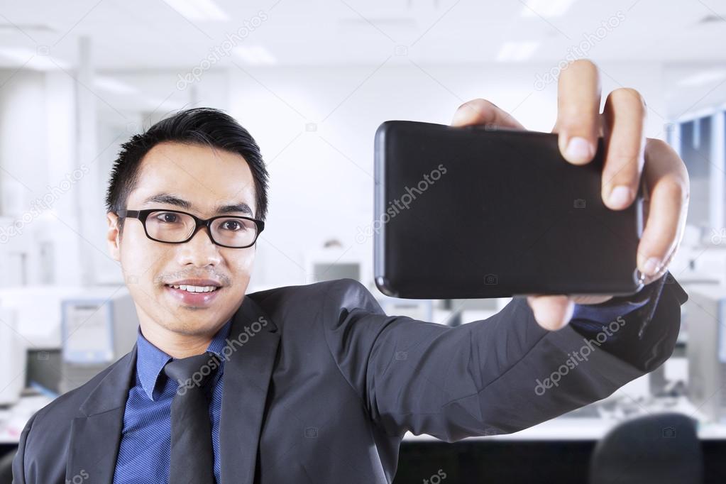 Male worker taking self photo