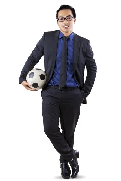 Male entrepreneur with soccer ball in studio — Stock Photo, Image