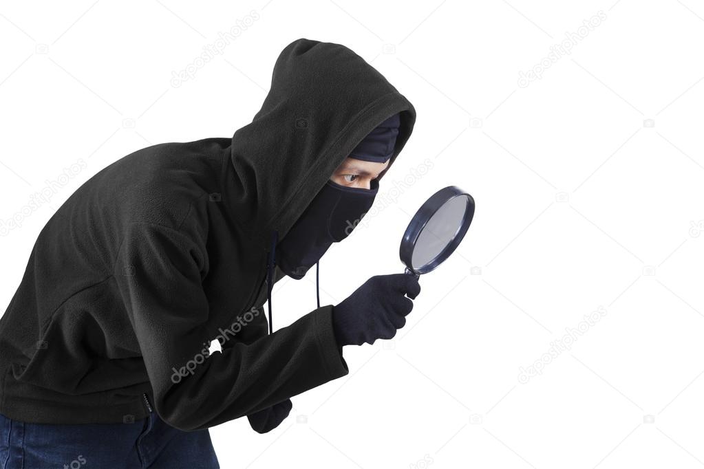 Man using magnifying glass for spying