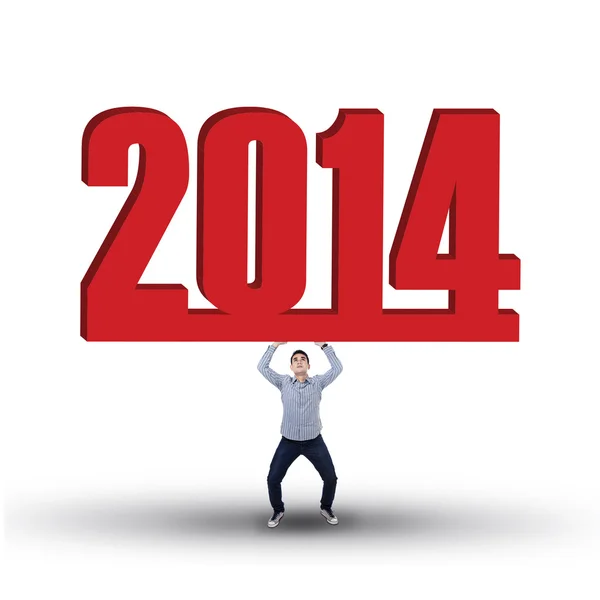 Casual businessman is lifting new year 2014 — Stock Photo, Image