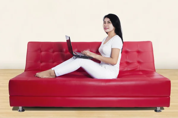 Donna casuale che utilizza il computer portatile a casa — Foto Stock