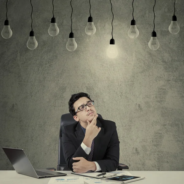 Creative manager looking at lightbulb — Stock Photo, Image