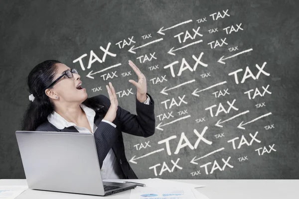 Frustrated female manager paying tax — Stock Photo, Image