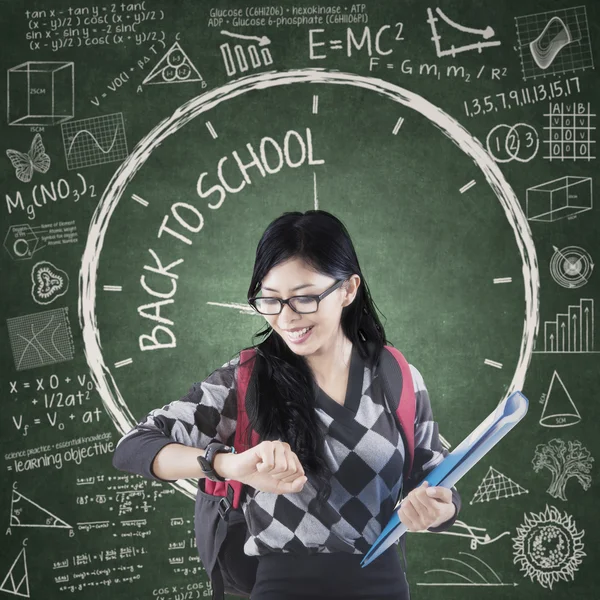 Female student with time of back to school — Stock Photo, Image