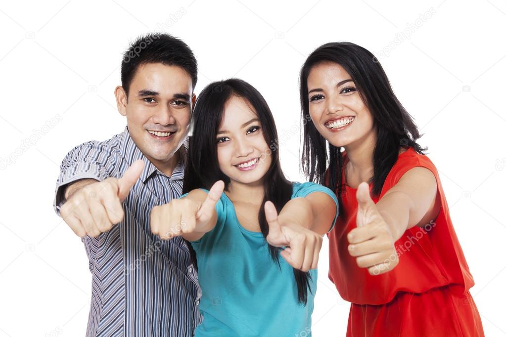 Cheerful friends showing thumbs-up 1