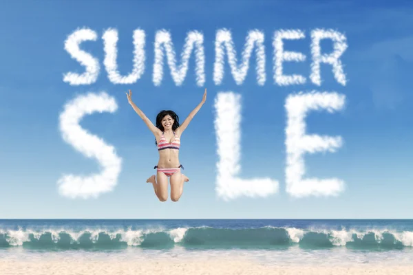 Model at beach with summer sale cloud — Stock Photo, Image