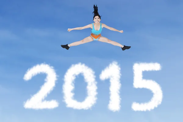 Healthy woman jumping over numbers 2015 — Stock Photo, Image
