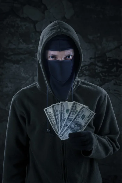 Robber holds money stolen — Stock Photo, Image