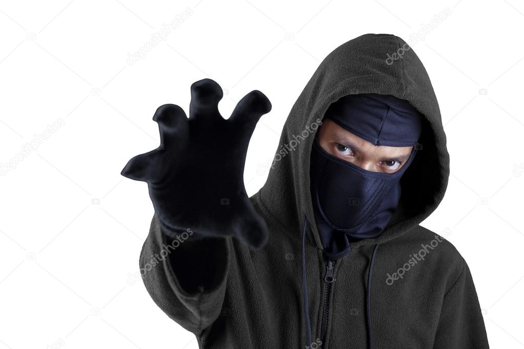 Male robber try to steal something