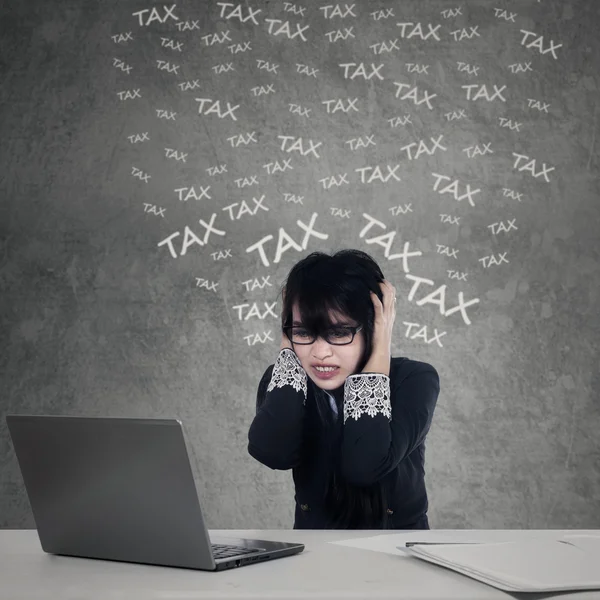 Frustrated female manager counting tax — Stock Photo, Image