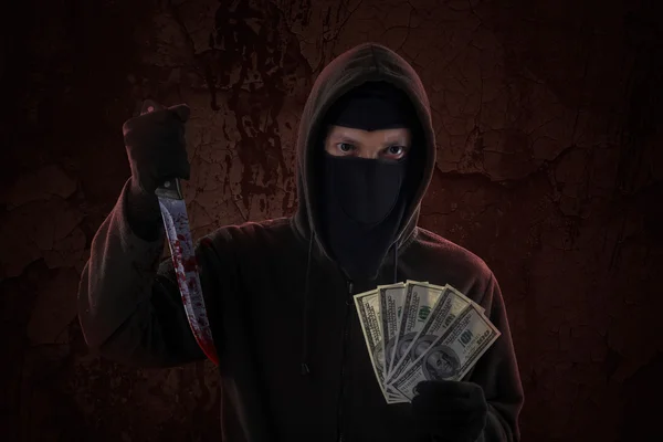 Male killer holds knife and money — Stock Photo, Image