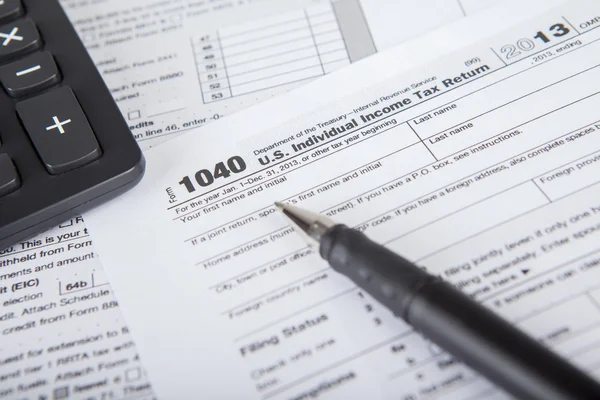 Pen with tax form and calculator — Stock Photo, Image