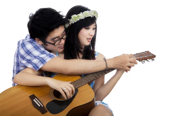 Guy enseñar a su novia a tocar la guitarra — Foto de Stock