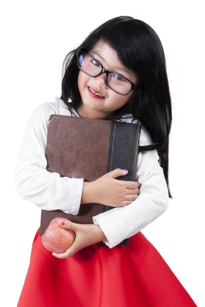 Criança bonita com livro e maçã — Fotografia de Stock