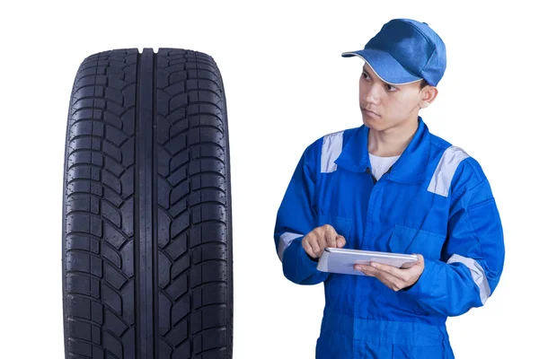 Asian mechanic controls a tire with tablet — Stock Photo, Image