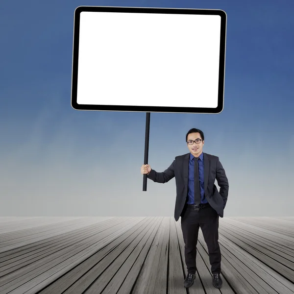 Business manager holding empty board — Stock Photo, Image