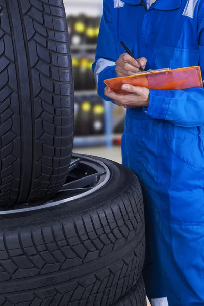 Mechanic examine the tires condition