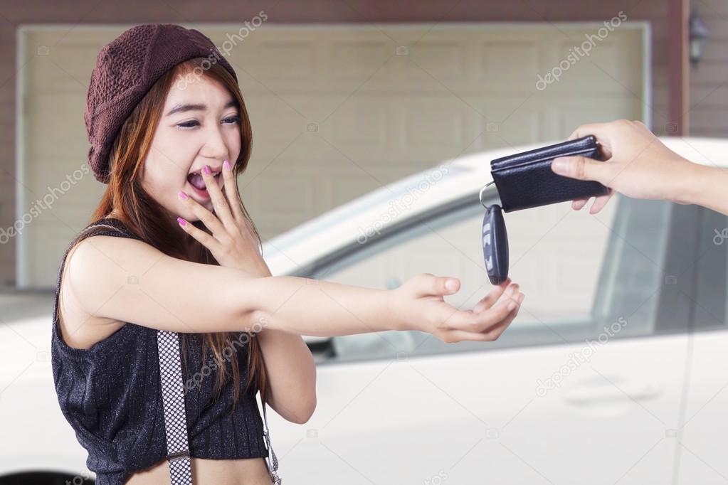 Teenage girl get a new car at garage