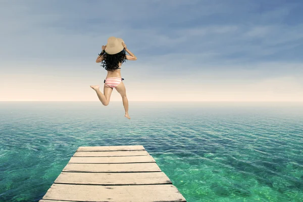 Happy woman jumping at pier 1 — Stock Photo, Image