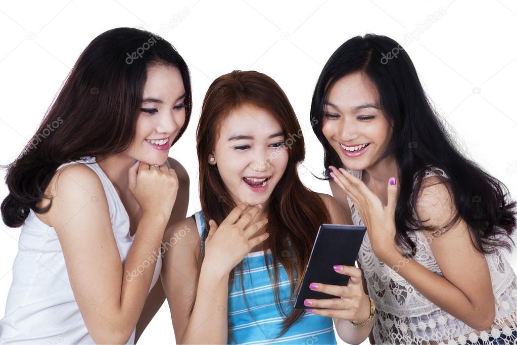 Group of girls reading message on cellphone