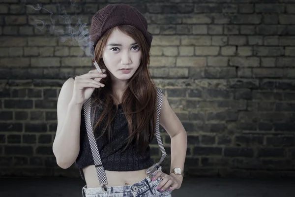 Schoolgirl holding a cigarette — Stock Photo, Image