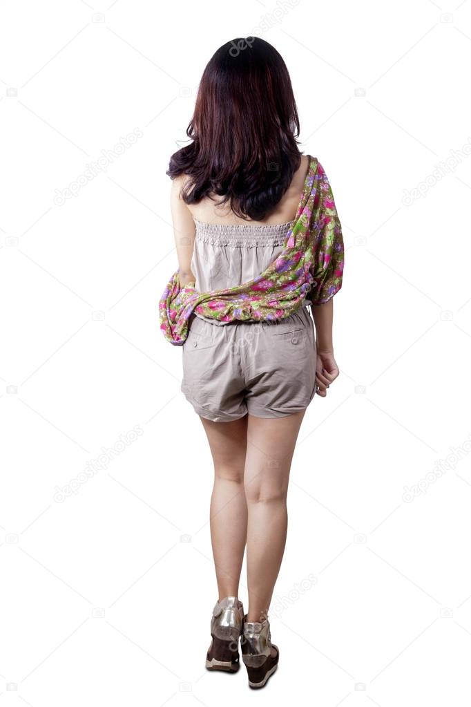 Rear view of girl walking in studio Stock Photo by ©realinemedia