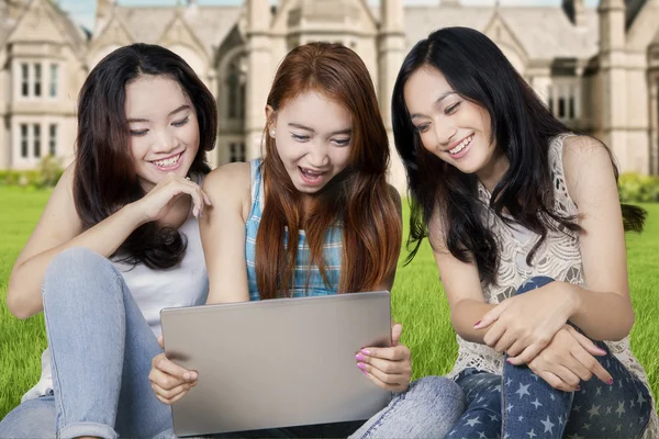 Teenage students with laptop at school yard — Stock Photo, Image