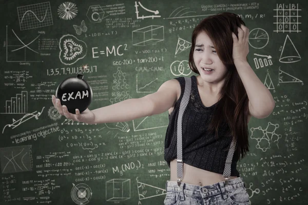 Worried student with bomb of exam — Stock Photo, Image