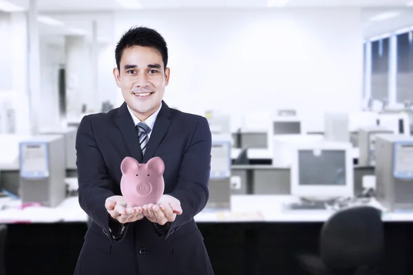 Businessman with a piggy bank — Stock Photo, Image