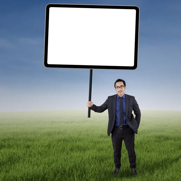 Businessman with empty copyspace at field — Stock Photo, Image