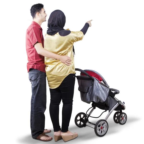 Young parents with a baby stroller — Stock Photo, Image