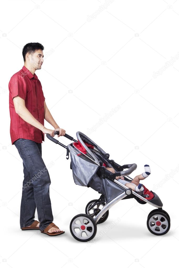 Young father pushing a baby carriage