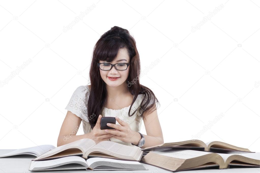 Student texting while studying 1
