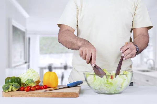 Homem fazendo salada orgânica — Fotografia de Stock