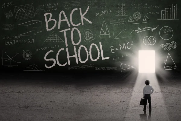 Male student leading to the door school — Stock Photo, Image