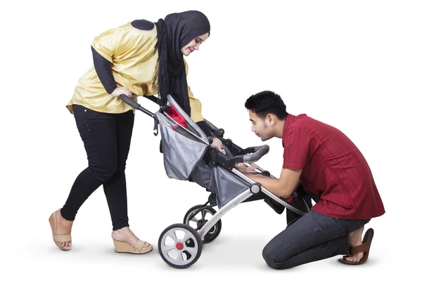 Genitori felici con bambino nel perdeambulatore — Foto Stock