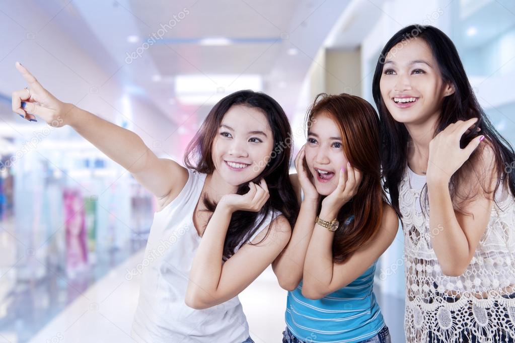 Excited adolescent girls at mall